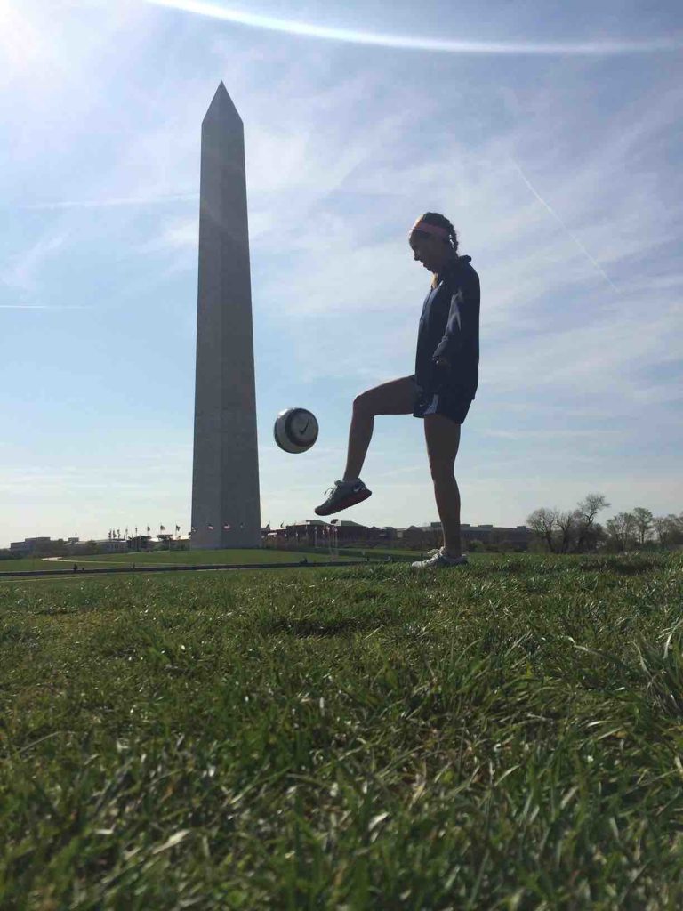 Claire haft juggling soccer ball in front of the Washington monument